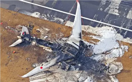  ?? ?? The burnt Japan Airlines Airbus A350 plane is seen at Haneda Internatio­nal Airport in Tokyo yesterday. — Xinhua