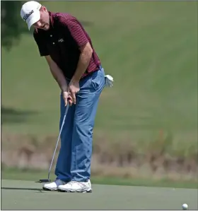  ?? (AP/Chris Seward) ?? Russell Henley putts for birdie on the 18th hole Thursday during the first round of the PGA Wyndham Championsh­ip at Sedgefield Country Club in Greensboro, N.C. Henley shot an 8-under 62 to lead the tournament by two shots.