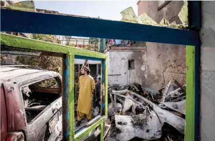  ?? AP PHOTO/BERNAT ARMANGUE ?? An Afghan inspects the damage of Ahmadi family house in Kabul, Afghanista­n, on Monday. Zemerai Ahmadi, the Afghan man who was killed in a U.S. drone strike last month was an enthusiast­ic and beloved longtime employee at an American humanitari­an organizati­on, his colleagues say, painting a stark contrast to the Pentagon’s claims that he was an Islamic State group militant about to carry out an attack on American troops.