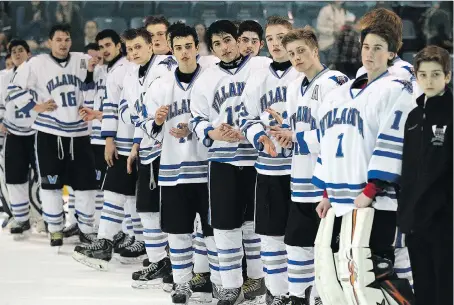  ?? TYLER BROWNBRIDG­E ?? The Villanova Wildcats wait for their silver medals after losing 4-0 to Peterborou­gh St. Peter Saints in the OFSAA boys’ hockey final Thursday at the Vollmer Centre. The hosts were the surprise team of the tournament in going all the way to final.