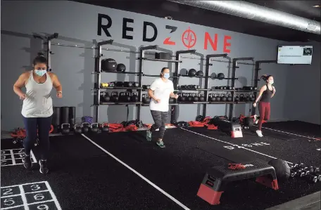  ?? Ned Gerard / Hearst Connecticu­t Media ?? RedZone members work out at a new fitness center in Weston, adhering to mask and distance rules in effect under Connecticu­t’s “2.1” safeguards to limit any transmissi­on of COVID-19.