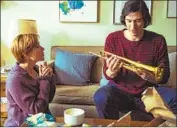  ?? Wilson Webb Netf lix ?? NICOLE (Scarlett Johansson) gives her husband, Charlie (Adam Driver), a gift in “Marriage Story.”