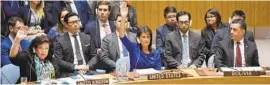  ?? HECTOR RETAMAL/AFP/GETTY IMAGES ?? British Ambassador to the U.N. Karen Pierce, left, and U.S. Ambassador to the U.N. Nikki Haley, center, vote during a Security Council meeting on Syria.