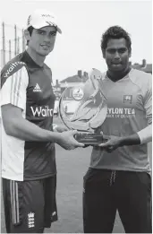  ?? — AFP ?? England cricket captain Alastair Cook ( left) and his Sri Lankan counterpar­t Angelo Mathews pose for pictures with the one- day series trophy at the Oval in London on Tuesday, ahead of the first ODI on Thursday.