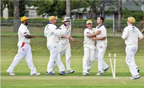  ?? Photo: Nev Madsen ?? GOT HIM: Kris Glass (no cap) celebrates with his teammates after taking a wicket for the Northern Brothers Diggers in their match with University at USQ on Saturday.