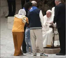  ?? GREGORIO BORGIA — THE ASSOCIATED PRESS ?? Pope Francis meets with refugee families in the Paul VI hall at the Vatican, Saturday, March 18, 2023.