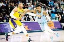  ?? (AP) ?? Memphis Grizzlies guard Ja Morant (12) drives to the basket defended by Los Angeles Lakers guard Russell Westbrook (0) in the second half of an NBA basketball game in Memphis, Tenn.