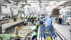  ??  ?? An employee at Abraham Moon and Sons woollen mill operates a weaving machine in Guiseley, northern England on March 30, 2016. Abraham Moon which was founded in 1837, run the last remaining vertical woollen mill in England, with the dyeing, blending,...