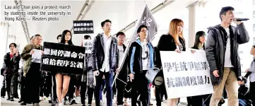  ??  ?? Lau and Chan joins a protest march by students inside the university in Hong Kong — Reuters photo