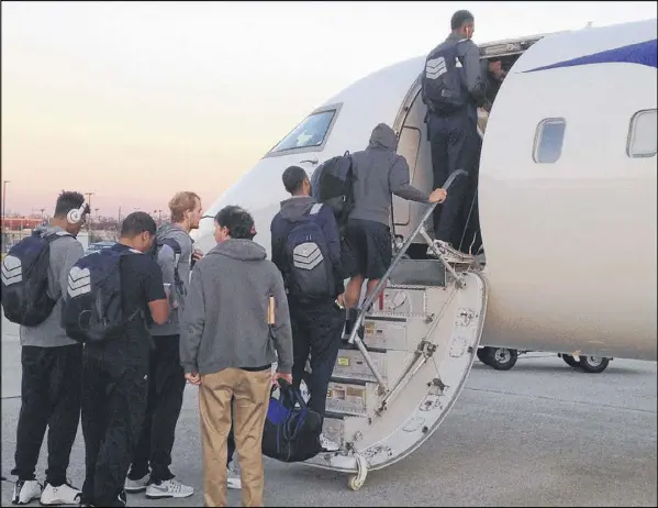  ??  ?? Tech players board their charter flight Feb. 3 at Hartsfield-Jackson Internatio­nal Airport. The jet’s ceiling was 6 feet, 1 inches high, and seats were similarly tight. Ben Lammers sat in back. “I’m pretty much one of the last ones that has to double...