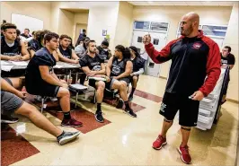  ?? PHOTOS BY RICHARD GRAULICH / THE PALM BEACH POST ?? Palm Beach Central players listen to Broncos head coach Tino Ierulli on Monday during spring football practice.