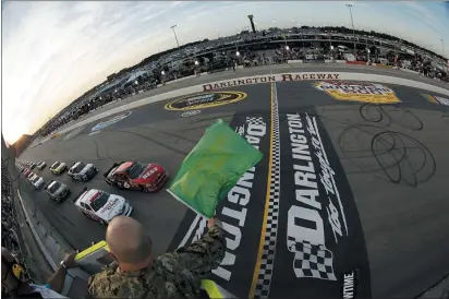  ?? TYLER BARRICK — AP POOL PHOTO ?? Drivers take the green flag for the start of a 2012NASCAR Nationwide Series race at Darlington Raceway in Darlington, S.C. NASCAR will re-fire the engines moments after mask-clad drivers climb into their cars at Darlington Raceway. The season will resume Sunday without spectators and drivers will have no practice before they pull away from pit road for the first time in more than two months.