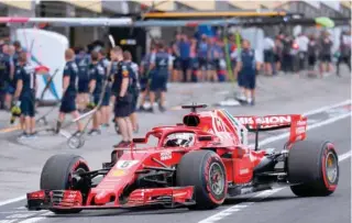  ?? — AFP ?? Ferrari’s German driver Sebastian Vettel makes a pit stop during the qualifying session of the Formula One Japanese Grand Prix at Suzuka on Saturday.