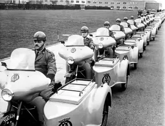  ??  ?? The last parade! A smart line-up of AA BSA patrol outfits is followed by their Mini van replacemen­ts from the BMC factory at Longbridge.