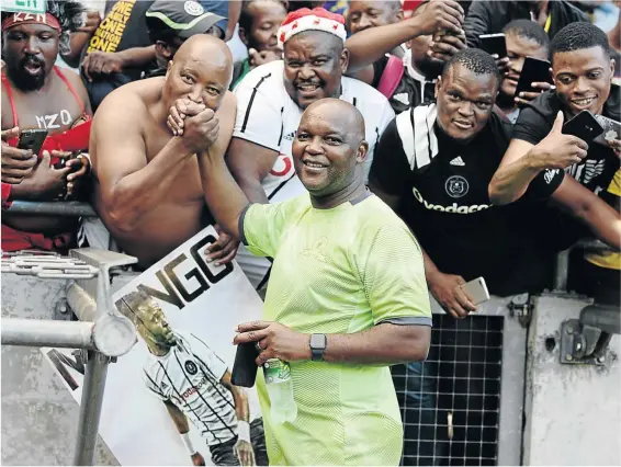  ?? /GALLO IMAGES / LEFTY SHIVAMBU ?? Mamelodi Sundowns coach Pitso Mosimane interacts with Orlando Pirates supporters at Orlando Stadium in Soweto, where the two teams met in an Absa Premiershi­p fixture on Wednesday night. Pirates won the game 1-0.