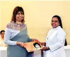  ?? ?? Santhoshin­i presenting her book to Sr. Sajani Fernando, principal of St. Bridget’s Convent