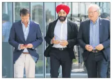  ?? STU NEATBY/THE GUARDIAN ?? Treasury Board president Scott Brison; Innovation, Science and Economic Developmen­t Minister Navdeep Bains; and P.E.I. Premier Wade MacLauchla­n emerge from meetings in Summerside on Tuesday.