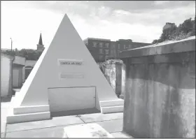  ??  ?? Cage's tomb: Actor Nicolas Cage is alive and well but he owns this gleaming tomb shaped like a pyramid in St. Louis Cemetery No. 1 in New Orleans, pictured in this June 3 photo. The white 9-foot-tall structure bears the words "omnia ab uno," which is...