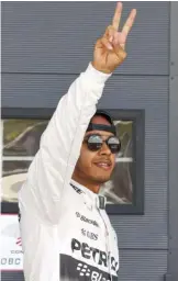  ??  ?? SILVERSTON­E: British Mercedes driver Lewis Hamilton celebrates after the qualifying for the British Formula One Grand Prix. — AP