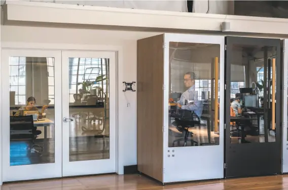  ?? Nick Otto / Special to The Chronicle ?? Employees have access to phone booths of sorts for private calls at the Fast office in San Francisco. Fewer than 10 employees of 228 have returned to the office.