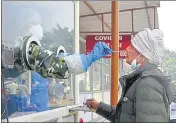  ?? DHEERAJ DHAWAN/HT PHOTO ?? A health worker taking swab sample of a man for corona test at RML Hospital in Lucknow on Wednesday.