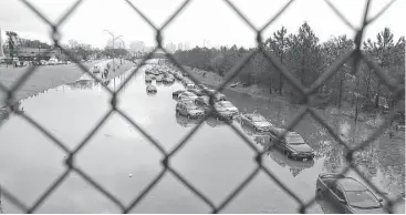  ?? Elizabeth Conley / Houston Chronicle ?? Drivers were forced to abandon their cars on a flooded section of Texas 288 near Calumet onWednesda­y morning after heavy overnight rainfall.