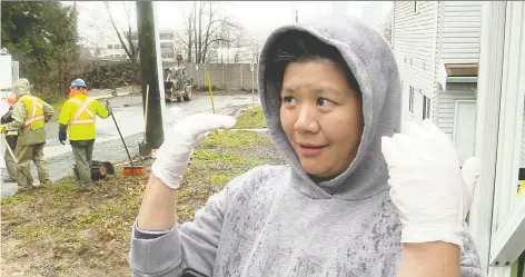  ??  ?? Mandy Yeh, who runs a daycare for eight children, says the backyard of her home where the children play is partly underwater after a water main on her block broke early Thursday. Yeh says it’s the fourth such flood in the 10 years she and her husband have lived in the house.
