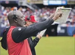  ?? SAN FRANCISCO Charles Rex Arbogast Associated Press ?? assistant head coach and running backs coach Anthony Lynn signals his players. The 49ers host Dallas on Sunday in a divisional playoff game.