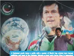  ?? — AFP ?? A Pakistani youth takes s selfie with a poster of World Cup cricket hero turned politician and head of the Pakistan Tehreek-e-Insaf party Imran Khan in Islamabad on July 30, 2018.