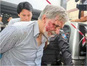  ?? — Reuters ?? Charged over crimes: Colter being escorted out of a vehicle after a raid in Bangkok.