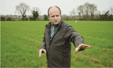  ?? Picture: AFP ?? LUSH. French farmer David Bonneau visits an experiment­al field in Mougon, western France.