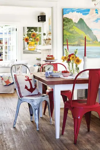  ??  ?? |RIGHT| SMALL BUT FABULOUS. This view
from the dining room into the living room shows just how well Carol has designed for
the small space.
|BELOW| NICELY AGED. A diptych of a hilltop
view out to the Channel Islands hangs prominentl­y in the living...