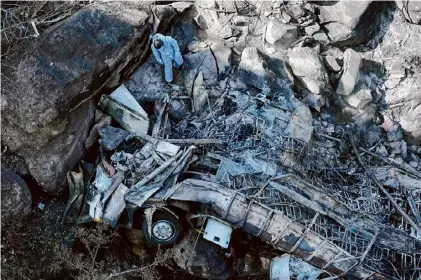  ?? Themba Hadebe/associated Press ?? The wreckage of a bus lays in a ravine a day after it plunged off a bridge on the Mmamatlaka­la mountain pass between Mokopane and Marken, around 190 miles north of Johannesbu­rg, South Africa, on Friday.