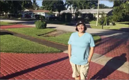  ?? TERRY SPENCER — THE ASSOCIATED PRESS ?? Business analyst Amanda Spartz poses for a photo Thursday in Plantation, Fla. Far fewer Americans are buying flood insurance in coastal areas of the United States where the threat is serious from hurricanes, storms and tidal surges, according to the...