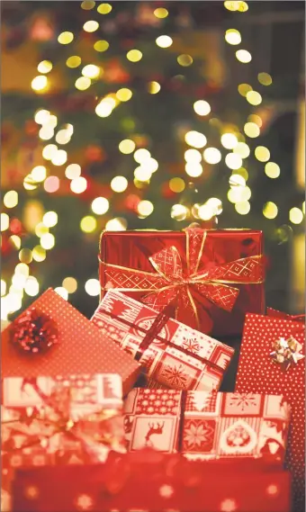  ?? Getty Images ?? Colorful and festive Christmas gifts. The National Retail Federation says retailers will hire between 530,000 to 590,000 seasonal workers this year, compared with 554,000 in 2018. They expect shoppers to shell out around $730 billion between November and December.