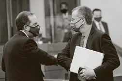  ?? Eric Gay / Associated Press ?? Bill Magness, president and CEO of the Electric Reliabilit­y Council of Texas, right, arrives to testify in Austin on Thursday. Natural gas operators and regulators blamed loss of power to their facilities for problems delivering the fuel last week.