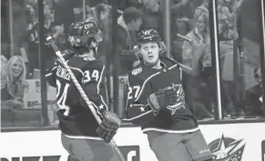  ?? NICOLAS GALINDO/THE COLUMBUS DISPATCH ?? Blue Jackets defenseman Adam Boqvist (27) and center Cole Sillinger celebrate a goal on Sunday.