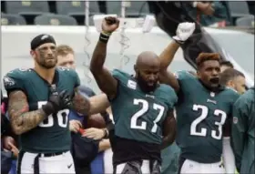  ?? MATT ROURKE — THE ASSOCIATED PRESS ?? Philadelph­ia Eagles defensive end Chris Long (56) stands beside Malcolm Jenkins (27) as he raises his fist during the national anthem before a preseason game. Long received a shoutout from former president Barack Obama in a tweet acknowledg­ing Long’s...