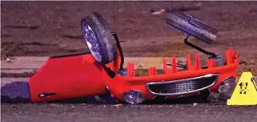  ??  ?? Smashed: Parts of a child’s red push-along car were left scattered by the roadside