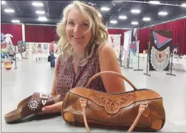 ?? NEWS PHOTOS GILLIAN SLADE ?? The cobbler of the pair of cowboy boots, that took top prize at the Better Living Show at Medicine Hat Exhibition & Stampede, is Susan Pahl-Gutfriend, from Rolling Hills, also made this leather handbag and her sandals.