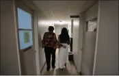  ?? REBECCA BLACKWELL — THE ASSOCIATED PRESS ?? A 33-year-old mother of three from central Texas is escorted down the hall by clinic administra­tor Kathaleen Pittman at Hope Medical Group for Women in Shreveport, La., on Saturday.