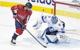  ?? ALEX BRANDON/ASSOCIATED PRESS ?? Lightning goaltender Andrei Vasilevski­y made 31 saves, including this one in the 1st period against Capitals center Evgeny Kuznetsov, to give his team a chance to clinch the series.