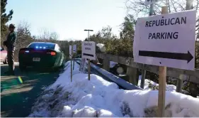  ?? (AP Photo/Charles Krupa, File) ?? In this Feb. 24, 2021, file photo, a sign directs Republican and Democrat legislator­s to their parking areas as a N.H. State Trooper watches the flow of traffic prior to a New Hampshire House of Representa­tives session held at NH Sportsplex, due to the coronaviru­s in Bedford, N.H. Amid calls to dial back hyper political partisansh­ip, two letters are among the obstacles standing in the way. Republican­s, including the lawyers who defended former President Donald Trump during last week’s impeachmen­t trial, routinely drop the “i-c” when referring to the Democratic Party or its policies.