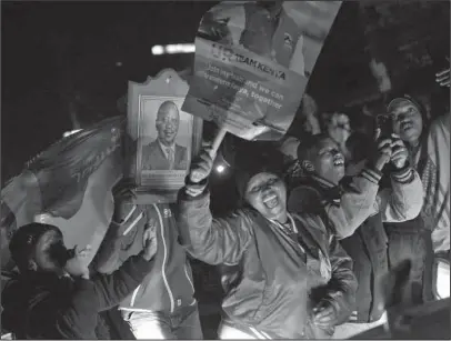  ?? The Associated Press ?? KENYA ELECTION: Supporters of President Uhuru Kenyatta celebrate Friday in Kikuyu Town, Kenya, after he was declared the winner of the presidenti­al election. Kenya's election commission announced Friday that President Uhuru Kenyatta has won a second...