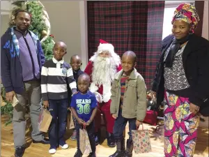  ?? PHOTO SUBMITTED BY SAAMIS IMMIGRATIO­N ?? Celebratin­g a first Christmas in Canada is the family of Andre Mafusi and Annette Hangi, seen here with children Exaucet, Glodi, Gradi and Gedeon during a visit from Santa Claus at the offices of Sammis Immigratio­n.