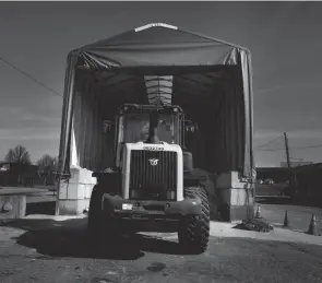  ?? BRYNN ANDERSON/AP ?? A tractor in Forest Park, Ga., sits in front of a pile of salt used to create a brine that will help clear roads of ice and snow.