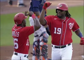  ?? LYNNE SLADKY - THE ASSOCIATED PRESS ?? Washington Nationals’ Josh Bell (19) is met by Victor Robles (16) after hitting a two-run home run during the first inning of a spring training baseball game against the Houston Astros, Wednesday, March 24, 2021, in West Palm Beach, Fl.