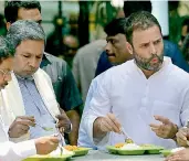  ?? — PTI ?? Congress vice-president Rahul Gandhi and Karnataka Chief Minister Siddaramai­ah eating food at the newly launched Indira Canteen in Bengaluru.