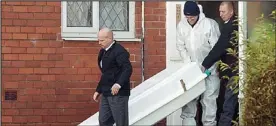  ??  ?? House of horror: Police removing Philip Marsden’s body yesterday