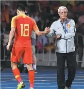  ?? XINHUA ?? Shanghai SIPG’s historic Chinese Super League triumph, fueled by the goals of Wu Lei (holding trophy), provided welcome respite for fans from the struggles of Marcello Lippi’s Team China (below) on the internatio­nal stage.